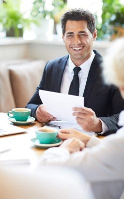 Cheerful lawyer talking to client in cafe